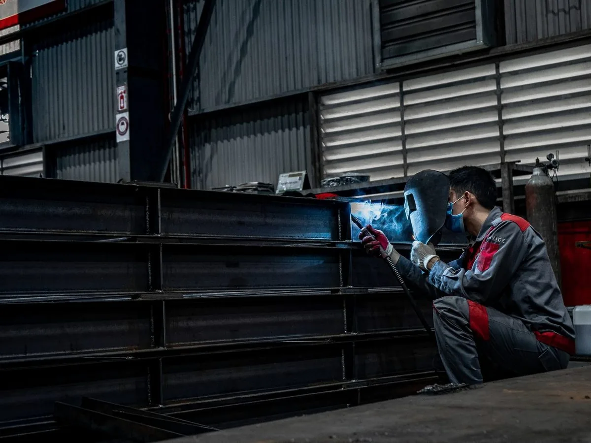 Welder fabricating steel in a shop on the Caspr system